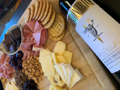 bottle of wine with charcuterie board